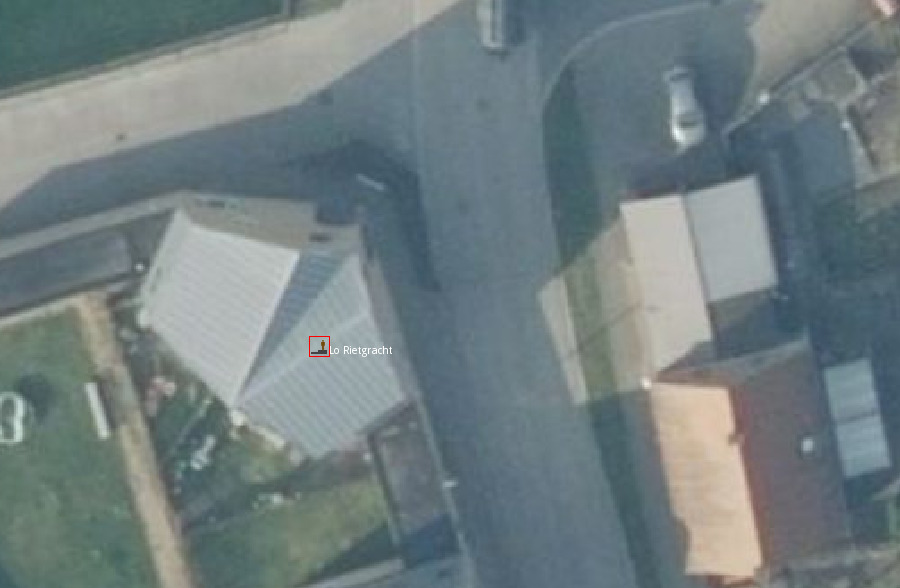 Aerial imagery of a small town, a bus stop is located in the middle of a house