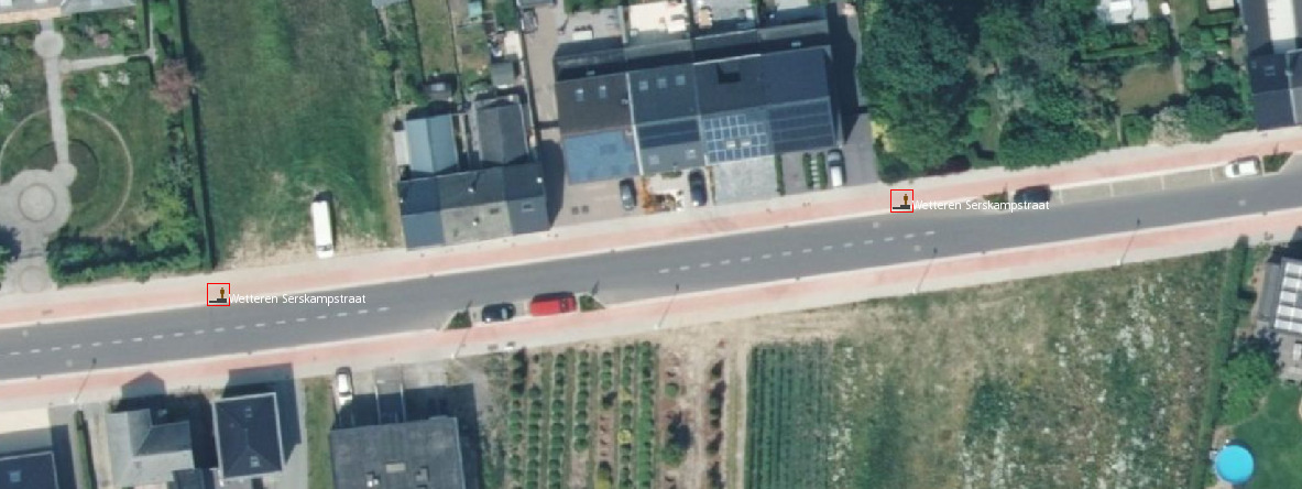 Aerial imagery of a street, with two bus stop nodes added from GTFS data, both on the northern sidewalk, despite we would expect one on each side